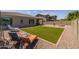 Artificial turf, fire pit, and patio furniture highlight this inviting backyard at 10550 E Sanger Ave, Mesa, AZ 85212