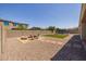 Spacious backyard with artificial turf and fire pit at 10550 E Sanger Ave, Mesa, AZ 85212