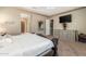 Spacious bedroom with large bed, dresser, and ensuite bathroom access at 10550 E Sanger Ave, Mesa, AZ 85212