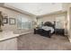 Main bedroom with large bed, ceiling fan and carpeted floor at 10550 E Sanger Ave, Mesa, AZ 85212