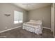 Bright bedroom with a queen-size bed and window coverings at 10550 E Sanger Ave, Mesa, AZ 85212