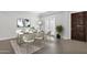 Formal dining room featuring elegant decor, a large table, and access to the outdoors through French doors at 10550 E Sanger Ave, Mesa, AZ 85212