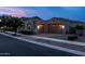 Evening view of house exterior with lights and landscaping at 10550 E Sanger Ave, Mesa, AZ 85212