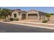 Spacious three-car garage with a tile roof and desert landscaping at 10550 E Sanger Ave, Mesa, AZ 85212