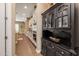 View of kitchen with dark wood hutch and white cabinets at 10550 E Sanger Ave, Mesa, AZ 85212