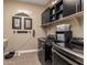 Well-organized laundry room featuring modern appliances, built-in storage, and stylish decor elements at 10550 E Sanger Ave, Mesa, AZ 85212