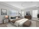 Serene main bedroom with a tray ceiling, neutral colors, and large windows for natural light, creating a relaxing retreat at 10550 E Sanger Ave, Mesa, AZ 85212
