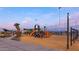 Children playing on a playground with modern play structures at 10550 E Sanger Ave, Mesa, AZ 85212