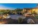 Landscaped backyard with a water feature, patio, and seating area at 10888 N 136Th Pl, Scottsdale, AZ 85259