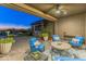 Covered patio with comfortable seating and an outdoor kitchen at 10888 N 136Th Pl, Scottsdale, AZ 85259