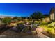 Fire pit with surrounding seating in a beautifully landscaped backyard at 10888 N 136Th Pl, Scottsdale, AZ 85259