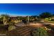 Landscaped backyard with a water feature, seating area, and fire pit at 10888 N 136Th Pl, Scottsdale, AZ 85259