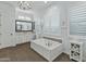 Elegant bathroom with soaking tub, double sinks, and plantation shutters at 10888 N 136Th Pl, Scottsdale, AZ 85259