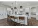 Bright kitchen featuring white cabinets, a large island with seating, and stainless steel appliances at 10888 N 136Th Pl, Scottsdale, AZ 85259