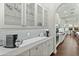 Kitchen features white shaker cabinets, gray backsplash, quartz countertops, and coffee bar at 10888 N 136Th Pl, Scottsdale, AZ 85259