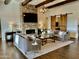 Elegant living room with a large stone fireplace, high ceilings, and a rustic barn door at 10888 N 136Th Pl, Scottsdale, AZ 85259