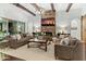 Spacious living room featuring a stone fireplace, high ceilings, and ample natural light at 10888 N 136Th Pl, Scottsdale, AZ 85259