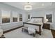 Main bedroom with large windows, plantation shutters, and a plush bed at 10888 N 136Th Pl, Scottsdale, AZ 85259