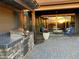 Outdoor kitchen and patio area with seating, pergola, and sunset view at 10888 N 136Th Pl, Scottsdale, AZ 85259