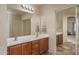 Double vanity bathroom with large mirror and tile floor at 11246 W Chase Dr, Avondale, AZ 85323