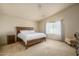 Large bedroom with wood furniture and carpeted floor at 11246 W Chase Dr, Avondale, AZ 85323