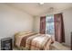 Bedroom with plaid bedspread and nightstand at 11246 W Chase Dr, Avondale, AZ 85323