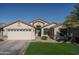 Single-story house with a two-car garage and well-maintained lawn at 11246 W Chase Dr, Avondale, AZ 85323