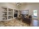 Living room with built-in shelving and a large TV at 11246 W Chase Dr, Avondale, AZ 85323