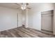 Bedroom with sliding door closet and wood-look floors at 11275 N 99Th Ave # 188, Peoria, AZ 85345