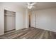 Light and airy bedroom with wood-look floors and ceiling fan at 11275 N 99Th Ave # 188, Peoria, AZ 85345