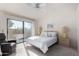 Main bedroom with private balcony access and ceiling fan at 11515 N 91St St # 248, Scottsdale, AZ 85260