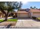 Tan two-story home with tile roof and attached garage at 11515 N 91St St # 248, Scottsdale, AZ 85260