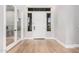 Bright entryway with wood-look floors and glass French doors at 1211 W Sousa Ct, Anthem, AZ 85086