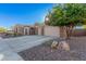 Attractive curb appeal with stone exterior and a three-car garage at 1211 W Sousa Ct, Anthem, AZ 85086