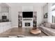 Gathering room featuring a modern fireplace and built-in shelving at 1211 W Sousa Ct, Anthem, AZ 85086