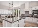 Modern kitchen with white cabinets, large island, and stainless steel appliances at 1211 W Sousa Ct, Anthem, AZ 85086