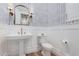 Stylish powder room featuring a pedestal sink and chevron wallpaper at 1211 W Sousa Ct, Anthem, AZ 85086