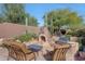 Relaxing patio with built-in fireplace and grill at 12238 E Poinsettia Dr, Scottsdale, AZ 85259