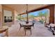 Covered patio features a table and chairs with pool views at 12238 E Poinsettia Dr, Scottsdale, AZ 85259