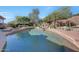 Inviting pool with a waterfall feature and desert landscaping at 12238 E Poinsettia Dr, Scottsdale, AZ 85259