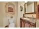 Elegant powder room featuring decorative wall and granite vanity at 12238 E Poinsettia Dr, Scottsdale, AZ 85259