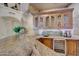 Wet bar with granite countertop, wooden cabinetry, and wine cooler at 12238 E Poinsettia Dr, Scottsdale, AZ 85259