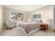 Bright bedroom with a comfortable bed and a relaxing armchair at 12923 W Ballad Dr, Sun City West, AZ 85375