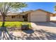 Tan one-story house with a two-car garage and well-maintained lawn at 12923 W Ballad Dr, Sun City West, AZ 85375