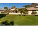 Back of house with covered patio and grassy yard at 12923 W Ballad Dr, Sun City West, AZ 85375