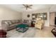 Spacious living room featuring a sectional sofa and large windows at 12923 W Ballad Dr, Sun City West, AZ 85375