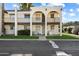 Tan two-story condo building with arched entryways and balconies at 131 N Higley Rd # 213, Mesa, AZ 85205