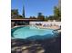 Community pool with lounge chairs and spa at 131 N Higley Rd # 213, Mesa, AZ 85205