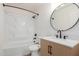 Clean bathroom with a white tub, modern vanity, and round mirror at 1326 W Seascape Dr, Gilbert, AZ 85233