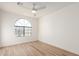 Bedroom with wood-look floors and an arched window at 1326 W Seascape Dr, Gilbert, AZ 85233